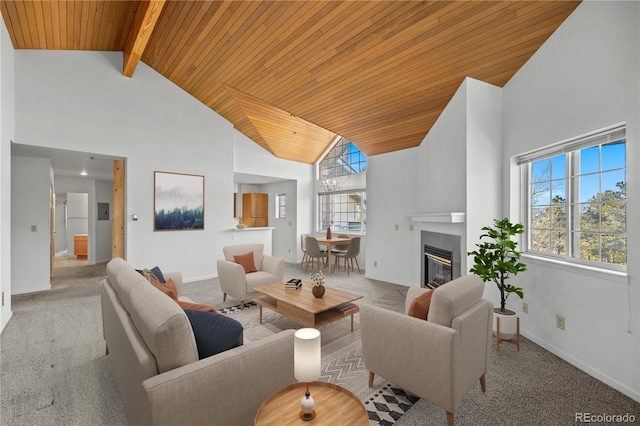 carpeted living room featuring beam ceiling, a healthy amount of sunlight, high vaulted ceiling, and baseboards