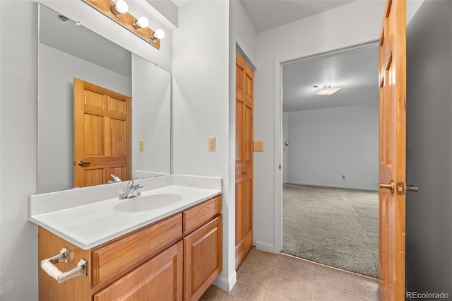 bathroom featuring vanity, tile patterned floors, and baseboards