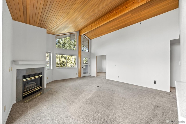 unfurnished living room featuring carpet floors, high vaulted ceiling, a fireplace with flush hearth, wooden ceiling, and beamed ceiling