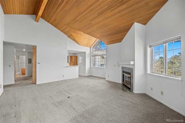 unfurnished living room with carpet floors, high vaulted ceiling, beam ceiling, and a fireplace with flush hearth