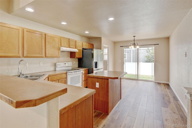 6836 Loudon St, Wellington, CO 80549 - kitchen featuring electric range, under cabinet range hood, a kitchen island, stainless steel fridge, and light wood-type flooring