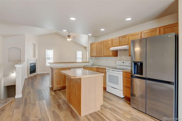6836 Loudon St, Wellington, CO 80549 - kitchen featuring stainless steel fridge, electric range, a peninsula, under cabinet range hood, and light brown cabinets