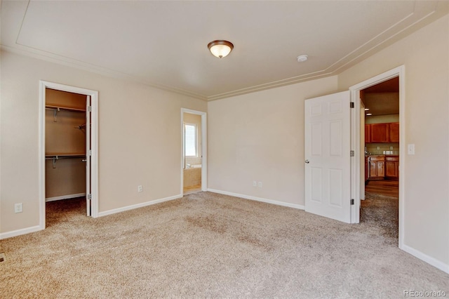 6836 Loudon St, Wellington, CO 80549 - unfurnished bedroom with carpet, a walk in closet, crown molding, and a closet