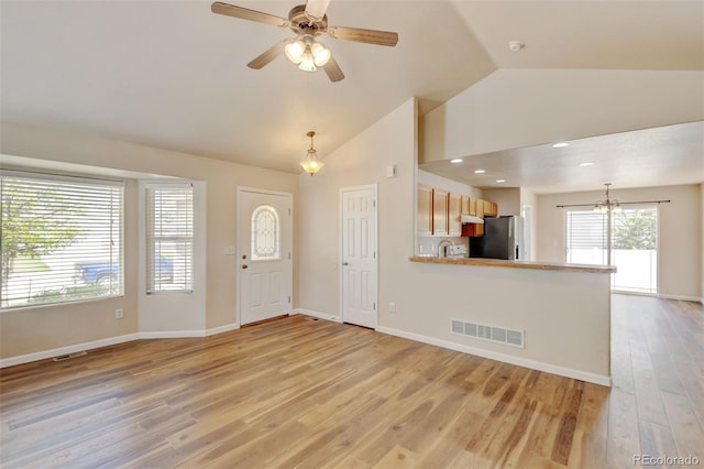 6836 Loudon St, Wellington, CO 80549 - entrance foyer featuring light wood-style flooring, ceiling fan, recessed lighting, a chandelier, and high vaulted ceiling