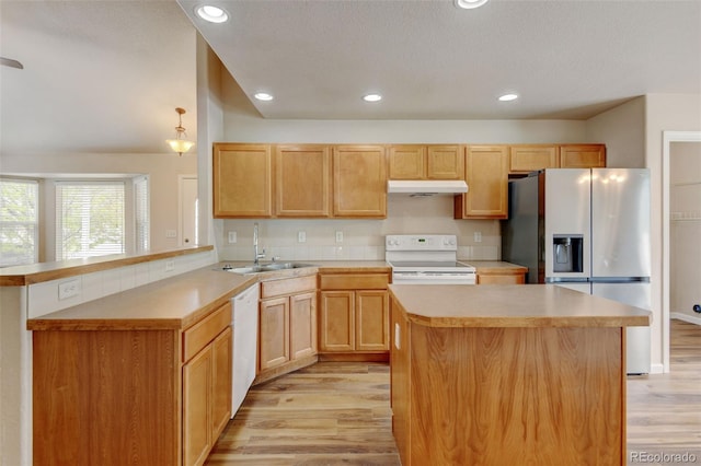 6836 Loudon St, Wellington, CO 80549 - kitchen featuring white appliances, under cabinet range hood, light wood-style floors, a peninsula, and light countertops