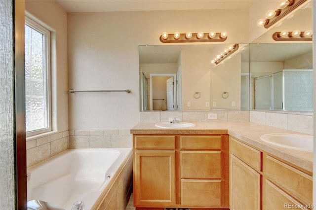 6836 Loudon St, Wellington, CO 80549 - full bath with healthy amount of natural light, a garden tub, double vanity, and an enclosed shower
