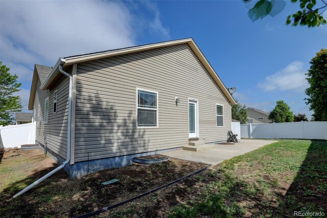 6836 Loudon St, Wellington, CO 80549 - rear view of property with a fenced backyard, a patio, and entry steps