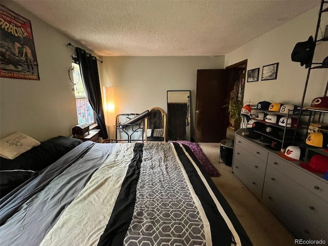 bedroom with a textured ceiling and carpet floors