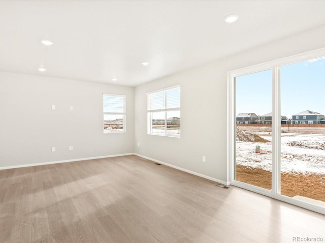 unfurnished room with light hardwood / wood-style flooring