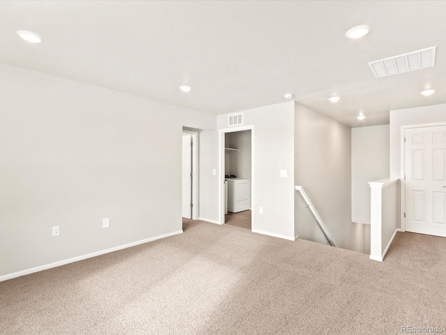 unfurnished room featuring carpet floors and washer / clothes dryer