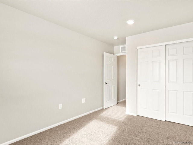 unfurnished bedroom with carpet floors and a closet