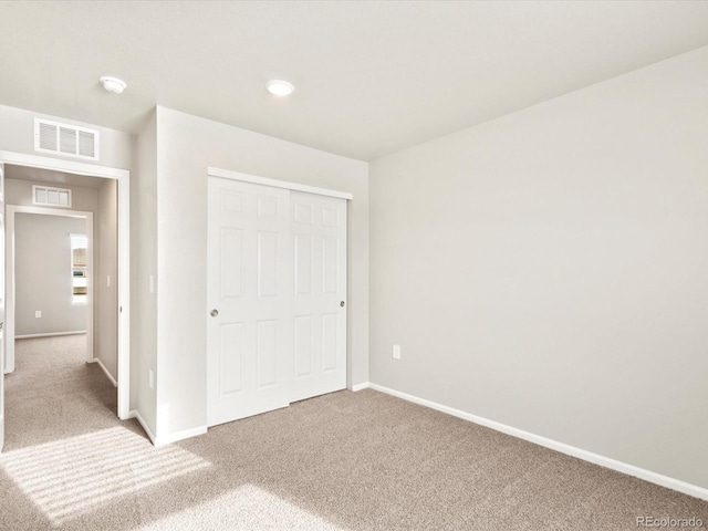 unfurnished bedroom featuring a closet and carpet floors