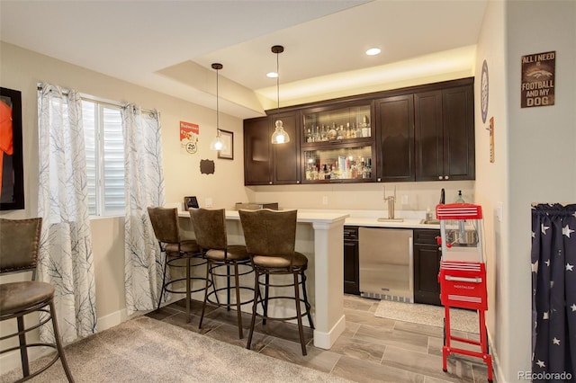 15122 Fillmore Way, Thornton, CO 80602 - indoor wet bar with hanging light fixtures, a raised ceiling, and recessed lighting