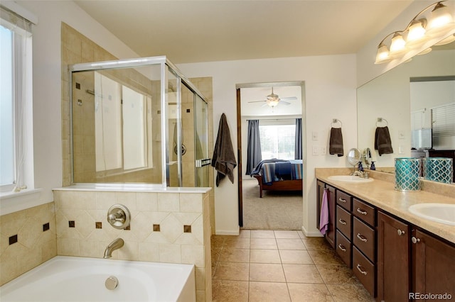 15122 Fillmore Way, Thornton, CO 80602 - ensuite bathroom featuring double vanity, a garden tub, a stall shower, ceiling fan, and tile patterned floors