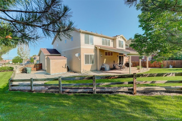 15122 Fillmore Way, Thornton, CO 80602 - rear view of house featuring a storage unit, a fenced backyard, and a patio