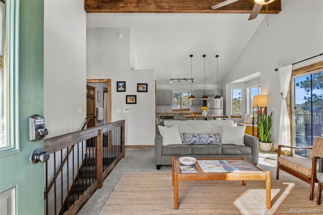 living room featuring high vaulted ceiling, track lighting, baseboards, and a ceiling fan