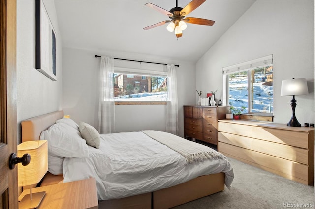 carpeted bedroom with vaulted ceiling and a ceiling fan