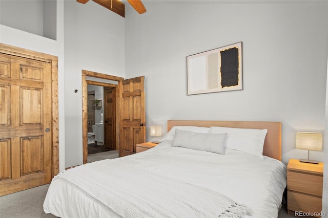 bedroom featuring ensuite bath, high vaulted ceiling, ceiling fan, and carpet flooring