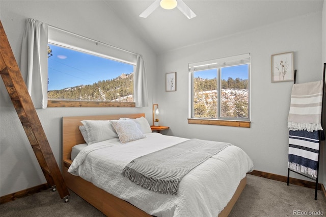 bedroom with vaulted ceiling, multiple windows, and carpet