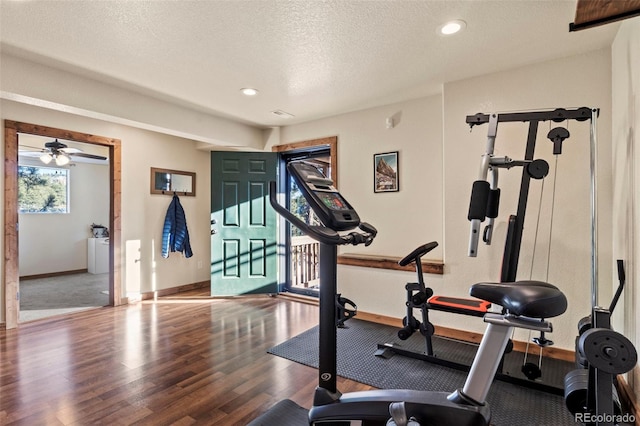 workout room featuring recessed lighting, a textured ceiling, baseboards, and wood finished floors