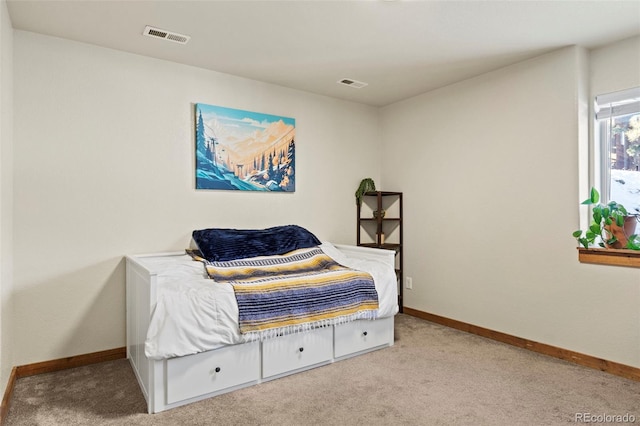 bedroom with light carpet, visible vents, and baseboards