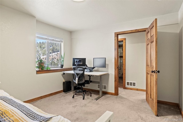 carpeted office with baseboards and visible vents