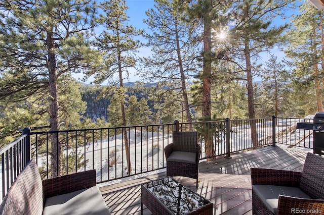 deck featuring a grill and a wooded view