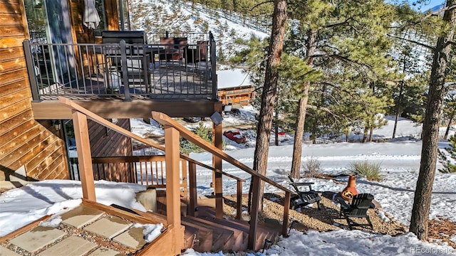 snow covered deck with stairs