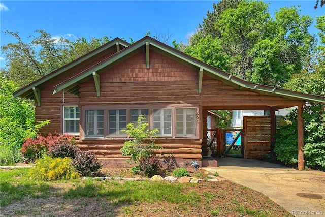 620 Walnut St, Windsor, CO 80550 - log home with concrete driveway, log siding, and entry steps