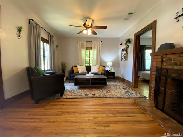 620 Walnut St, Windsor, CO 80550 - living room featuring wood finished floors, a ceiling fan, and a fireplace