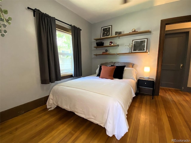 620 Walnut St, Windsor, CO 80550 - bedroom with hardwood / wood-style flooring and baseboards