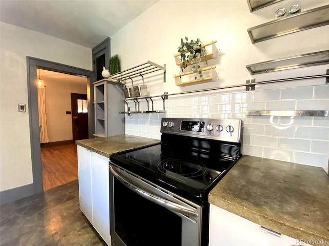 620 Walnut St, Windsor, CO 80550 - kitchen featuring stainless steel range with electric stovetop, dark countertops, backsplash, open shelves, and white cabinetry