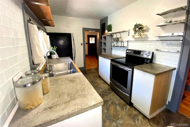 620 Walnut St, Windsor, CO 80550 - kitchen with electric range, open shelves, tasteful backsplash, and white cabinetry