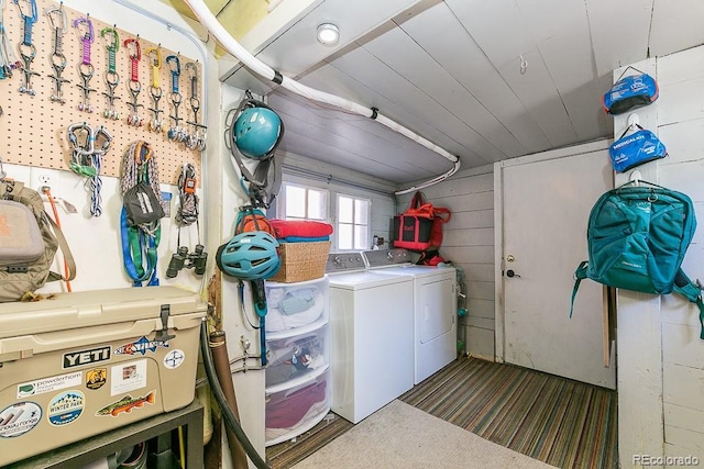 620 Walnut St, Windsor, CO 80550 - laundry area with washing machine and clothes dryer, carpet flooring, and wooden walls