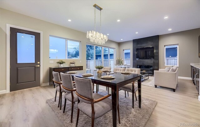 dining room with light hardwood / wood-style flooring and a notable chandelier