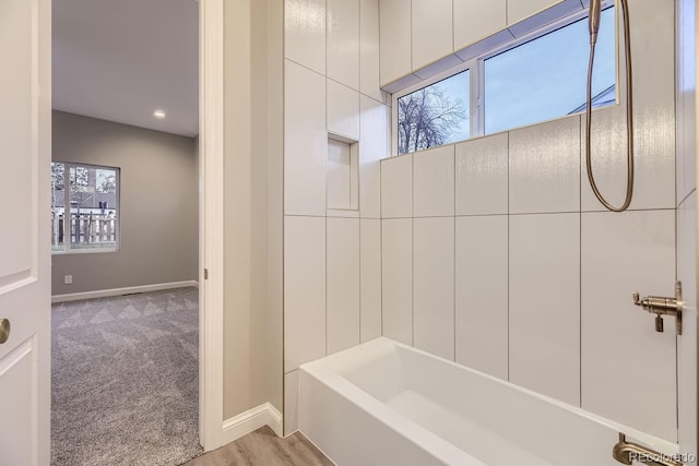 bathroom featuring a wealth of natural light and hardwood / wood-style flooring