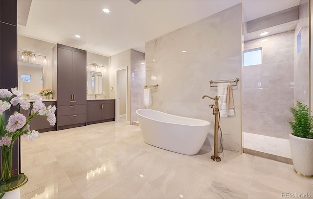 bathroom with vanity and separate shower and tub