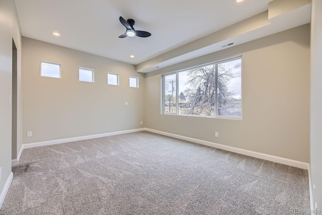 unfurnished room with ceiling fan, a healthy amount of sunlight, and carpet flooring