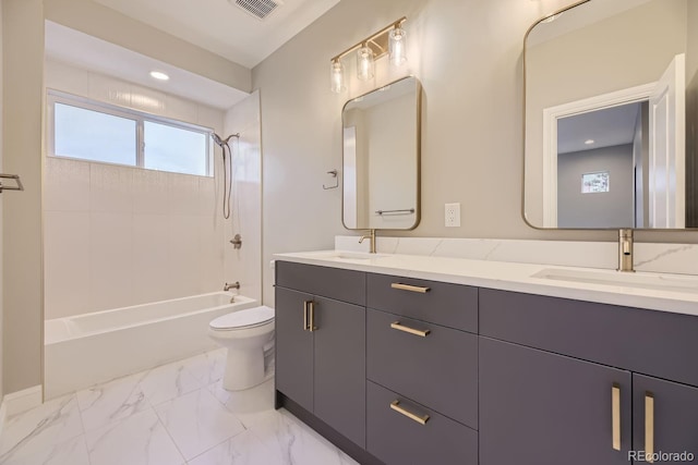 full bathroom with vanity, tiled shower / bath combo, and toilet