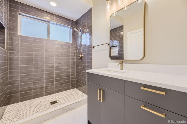 bathroom featuring vanity and tiled shower