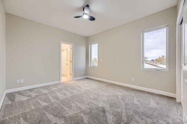 empty room with ceiling fan and carpet flooring