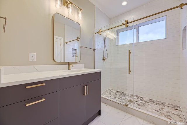 bathroom featuring walk in shower and vanity