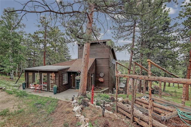 119 Yew Ln, Bailey, CO 80421 - rear view of property featuring a garden, a deck, and a shingled roof