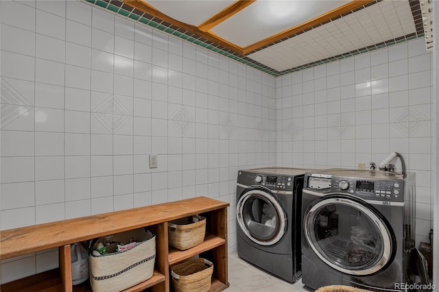 119 Yew Ln, Bailey, CO 80421 - laundry area with tile walls and washing machine and dryer