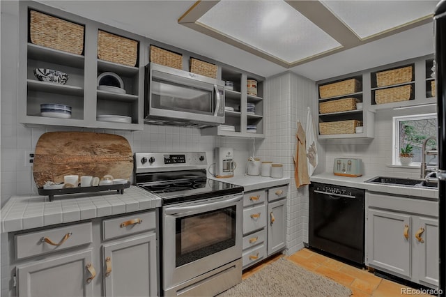 119 Yew Ln, Bailey, CO 80421 - kitchen featuring appliances with stainless steel finishes, open shelves, backsplash, and light tile patterned floors