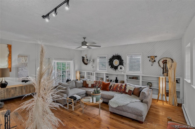 119 Yew Ln, Bailey, CO 80421 - living area with a textured ceiling, baseboard heating, ceiling fan, hardwood / wood-style floors, and track lighting
