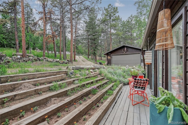 119 Yew Ln, Bailey, CO 80421 - deck with an outbuilding, a detached garage, and view of scattered trees