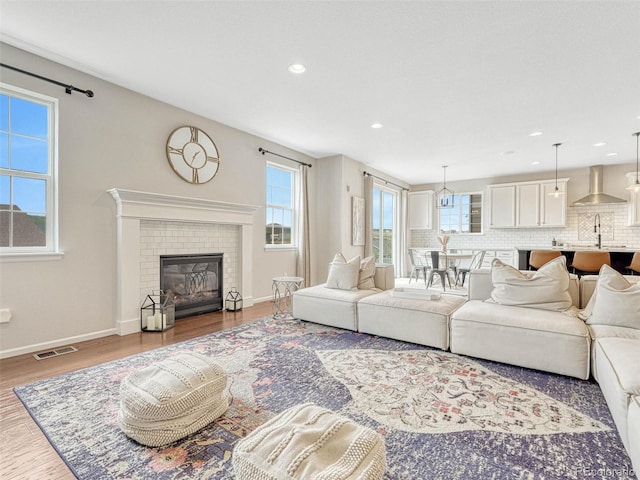 living room with a fireplace and light hardwood / wood-style floors