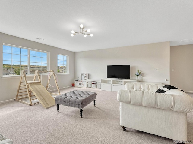 carpeted living room featuring an inviting chandelier