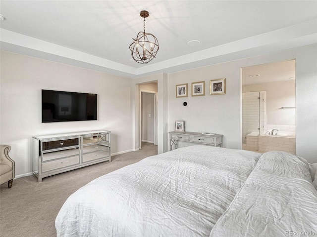 carpeted bedroom with ensuite bathroom and a notable chandelier